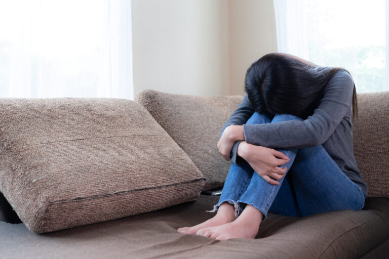 HQ emotional young woman was depressed sofa